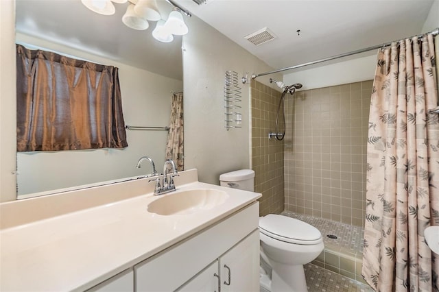 full bath featuring visible vents, vanity, toilet, and tiled shower