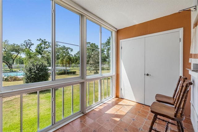 unfurnished sunroom featuring a textured ceiling