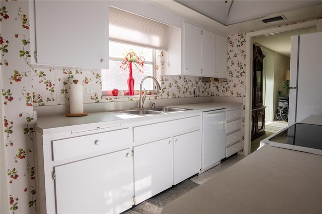 2630 Pearce Dr Unit 104, Clearwater, FL 33764 - kitchen with white appliances, white cabinetry, visible vents, a sink, and wallpapered walls
