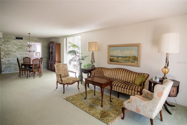 2630 Pearce Dr Unit 104, Clearwater, FL 33764 - carpeted living area with a notable chandelier, visible vents, and wallpapered walls