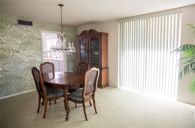 2630 Pearce Dr Unit 104, Clearwater, FL 33764 - dining area with light carpet, a notable chandelier, visible vents, and wallpapered walls