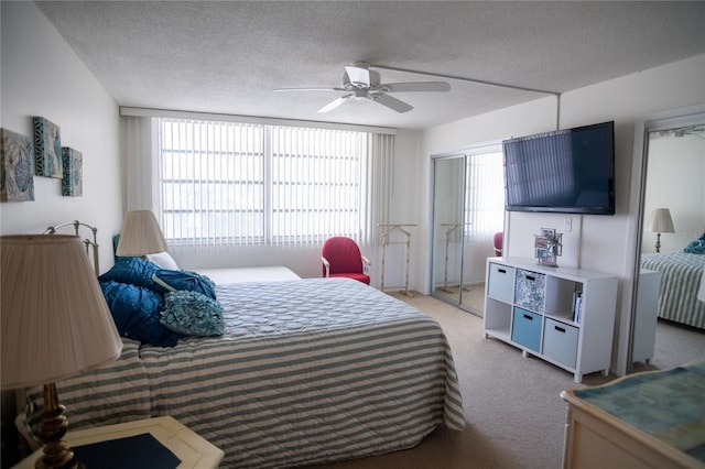 2630 Pearce Dr Unit 104, Clearwater, FL 33764 - bedroom with a textured ceiling, ceiling fan, and carpet