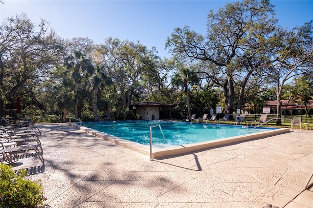 2630 Pearce Dr Unit 104, Clearwater, FL 33764 - community pool featuring a patio and fence