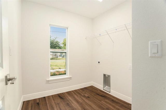 washroom with electric dryer hookup, laundry area, dark wood finished floors, and a healthy amount of sunlight