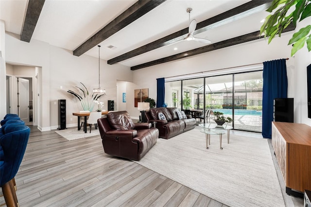 living area featuring baseboards, a ceiling fan, beam ceiling, and light wood-style flooring