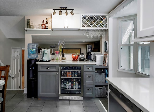 bar with dishwasher, a dry bar, tile patterned flooring, and wine cooler