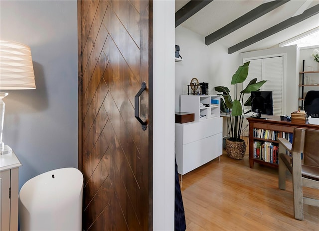 interior space featuring lofted ceiling with beams and light wood-type flooring