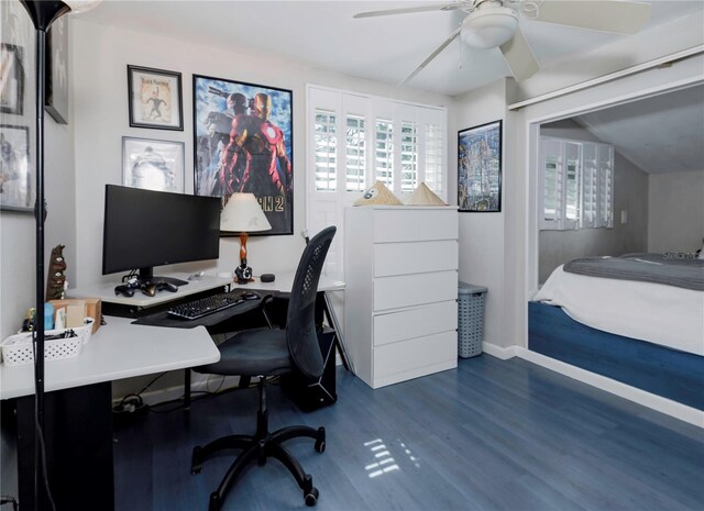 office space featuring baseboards, dark wood-type flooring, and a ceiling fan