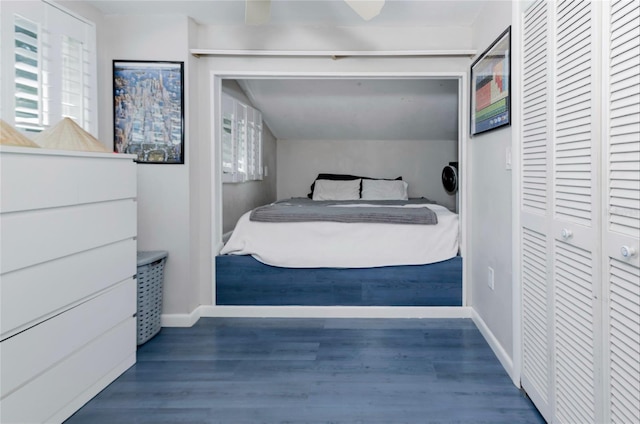 bedroom featuring a closet, wood finished floors, and baseboards