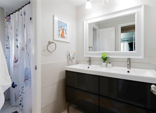 bathroom with tile patterned flooring, double vanity, and a sink