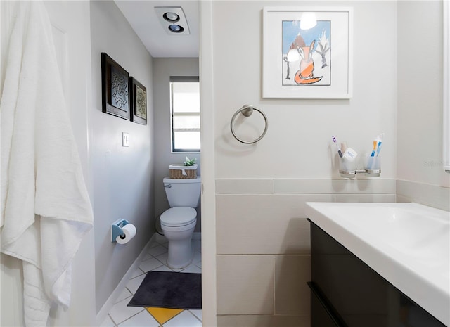 bathroom featuring toilet, tile patterned flooring, and vanity