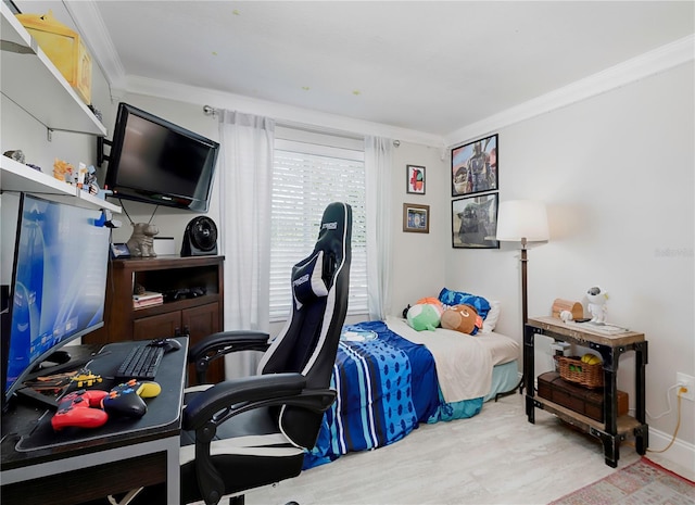 bedroom with ornamental molding and wood finished floors