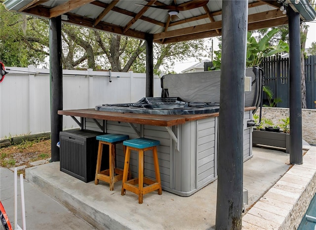 view of patio / terrace featuring a fenced backyard, a gazebo, and outdoor dry bar