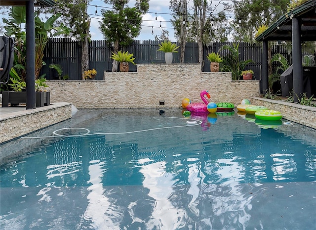 view of swimming pool featuring a fenced backyard