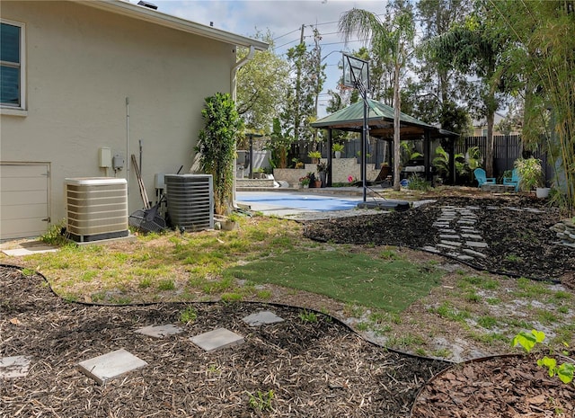 view of yard with central AC unit, a gazebo, a patio area, and fence