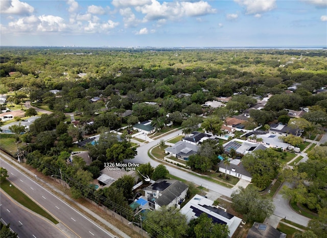aerial view with a wooded view and a residential view