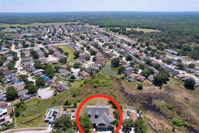 birds eye view of property featuring a residential view and a forest view