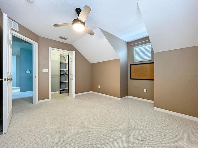 bonus room with visible vents, light carpet, ceiling fan, and lofted ceiling