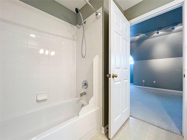 bathroom featuring shower / tub combination, tile patterned floors, and baseboards