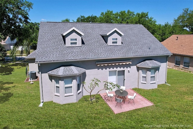 rear view of property with stucco siding, central AC unit, a yard, and a patio area