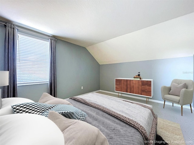 bedroom featuring vaulted ceiling, carpet, and baseboards