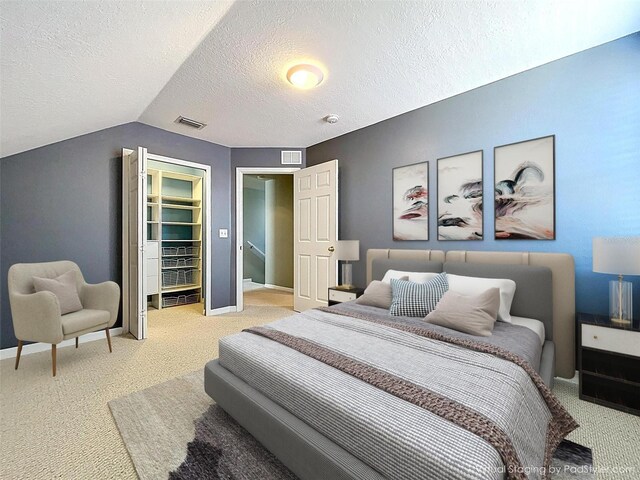 bedroom featuring baseboards, visible vents, carpet flooring, and vaulted ceiling