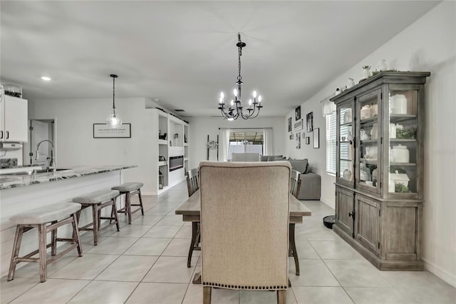 dining area with a wealth of natural light, an inviting chandelier, baseboards, and light tile patterned flooring