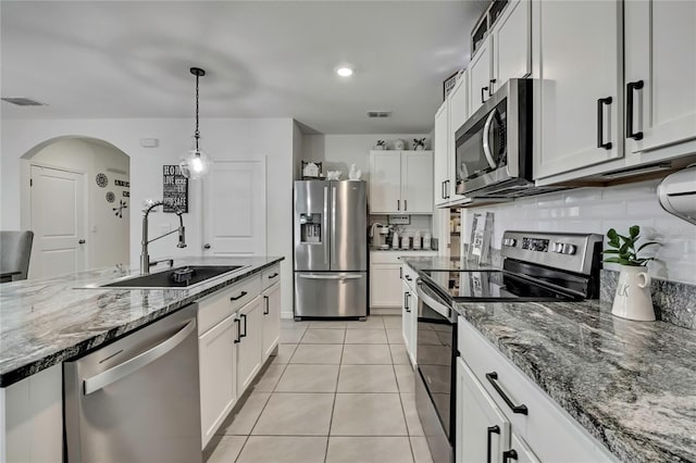kitchen with light tile patterned flooring, a sink, visible vents, and stainless steel appliances