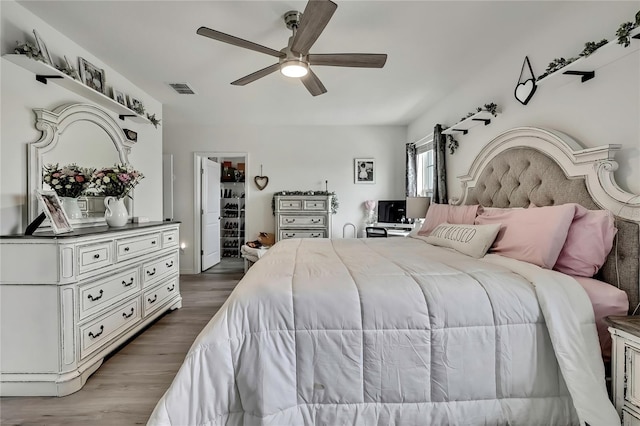 bedroom featuring dark wood-style flooring, visible vents, and a ceiling fan