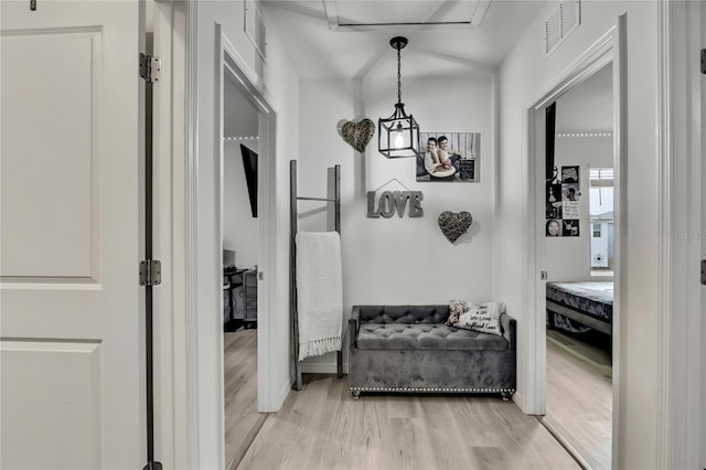 hallway featuring visible vents and light wood-style floors