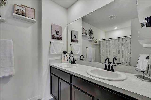 full bathroom featuring double vanity, a sink, and visible vents