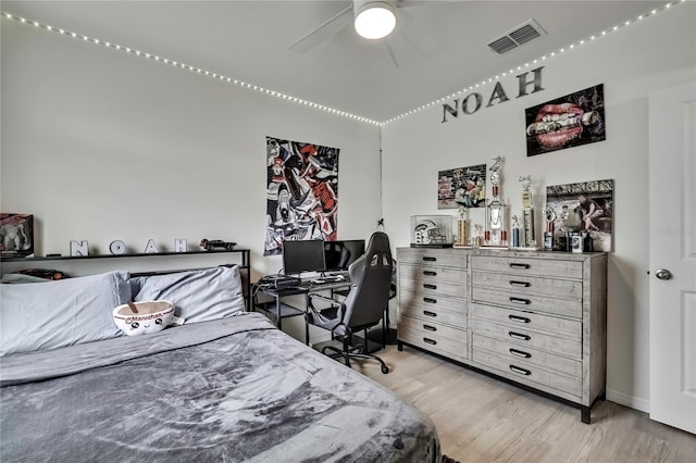 bedroom with visible vents, light wood-type flooring, and a ceiling fan