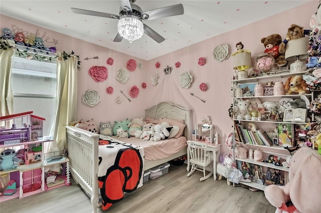 bedroom with a ceiling fan and wood finished floors