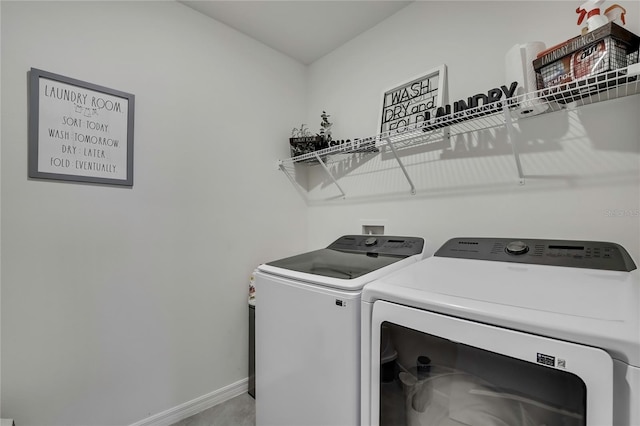 laundry room featuring separate washer and dryer, laundry area, and baseboards