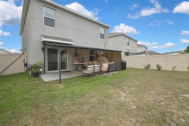 back of property with a yard, a fenced backyard, a patio, and stucco siding