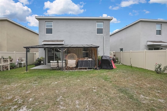 rear view of property with a patio area, a fenced backyard, a lawn, and stucco siding