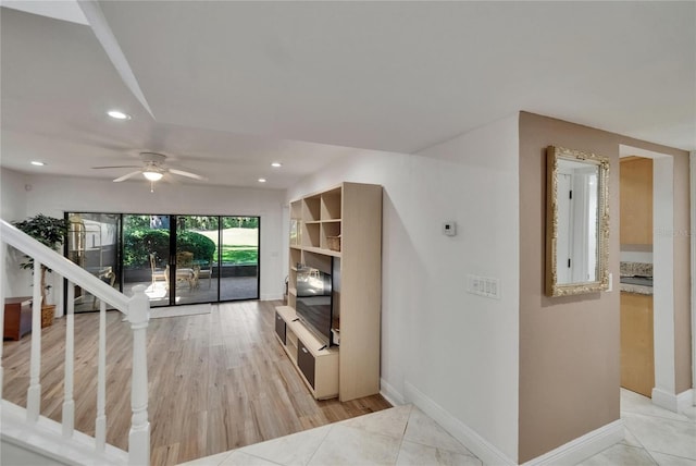 living room with light wood-style flooring, a ceiling fan, recessed lighting, stairs, and baseboards