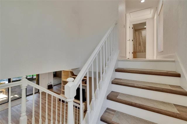 stairs featuring wood finished floors