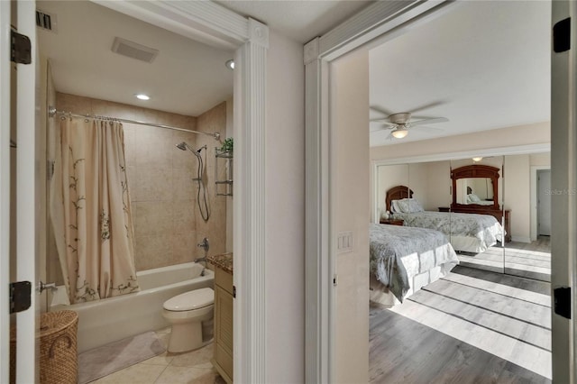 full bathroom featuring visible vents, shower / bath combination with curtain, ceiling fan, ensuite bath, and tile patterned flooring