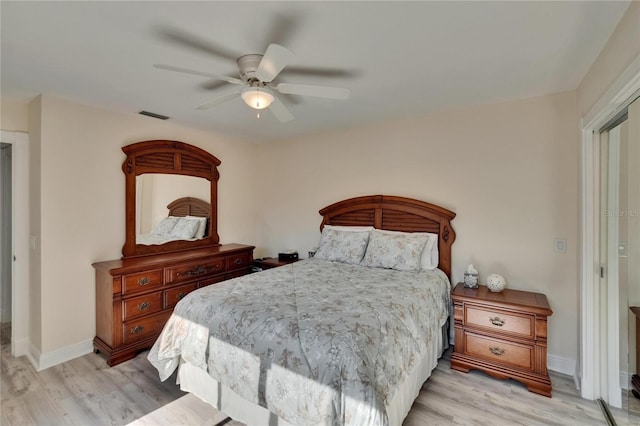 bedroom with baseboards, light wood finished floors, ceiling fan, and visible vents