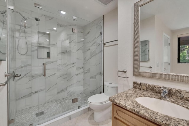 full bath with a marble finish shower, visible vents, toilet, and vanity