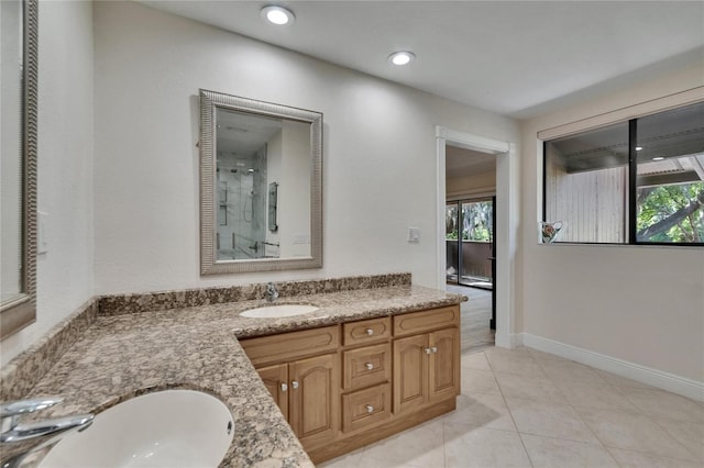 bathroom with vanity, baseboards, tile patterned flooring, recessed lighting, and a shower