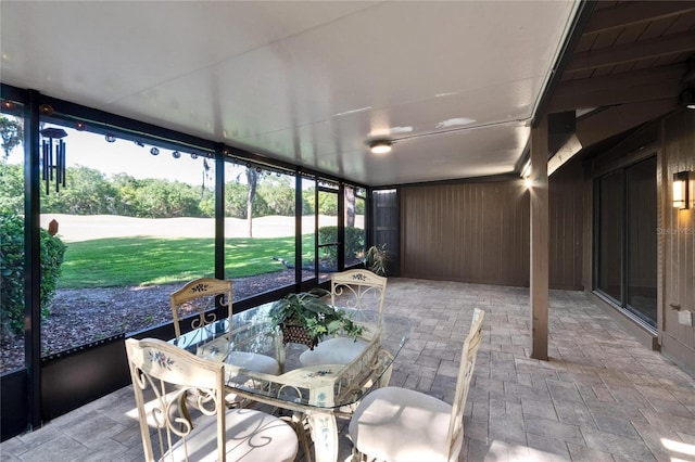 unfurnished sunroom featuring outdoor dining area
