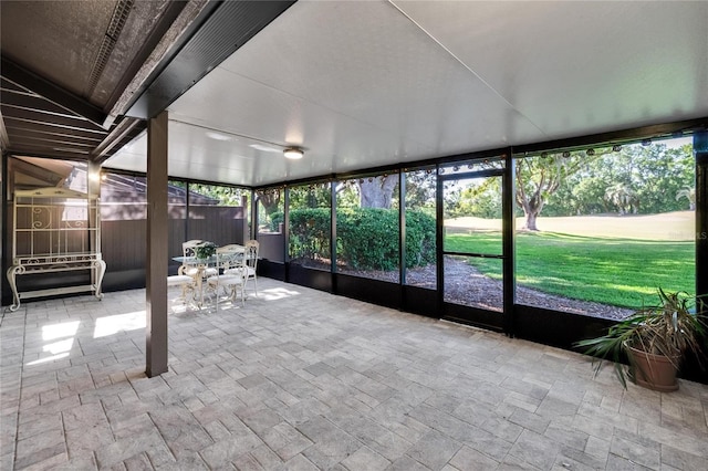 unfurnished sunroom featuring outdoor dining area