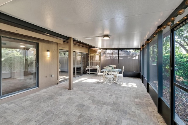 unfurnished sunroom featuring outdoor dining area
