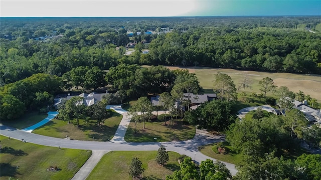 drone / aerial view with a wooded view