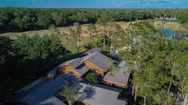 drone / aerial view featuring a water view and a forest view
