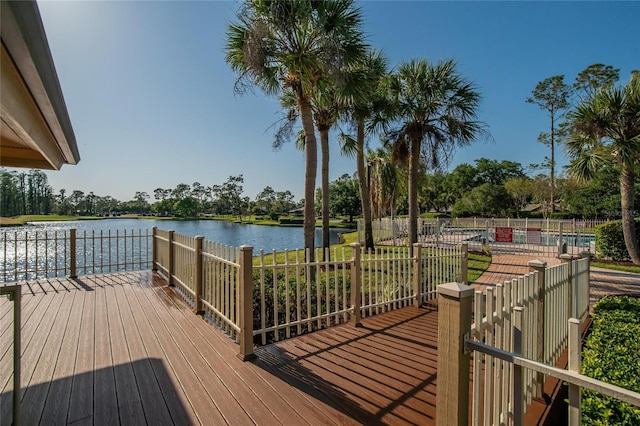 wooden deck with fence and a water view