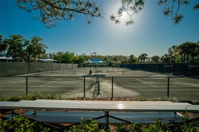 view of tennis court with fence