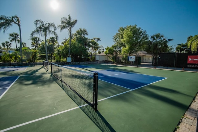view of sport court featuring fence